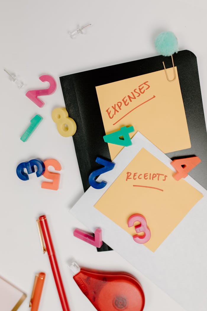 why-choose-us-02 Flat lay of colorful office supplies and sticky notes labeled 'Expenses' and 'Receipts'.
